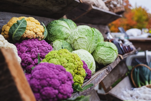 cabbage and cauliflower displayed at a market